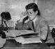 John F. Kennedy sits and studies at his desk at Harvard, c. 1939