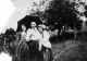 Two Girls and a Man with an Umbrella