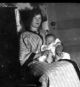 Coral Leader Litzgus holding a baby - probably Alfred Clayton or Eleanor