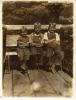 Elbert, Floyd, and Ted Michael sitting on a bench